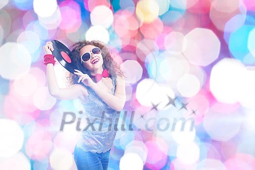 Young pretty girl dj at disco party holding vinyl Young pretty girl dj at disco party holding vinyl