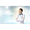 Young handsome doctor with stethoscope against white background