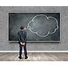 Rear view of businessman looking at chalkboard