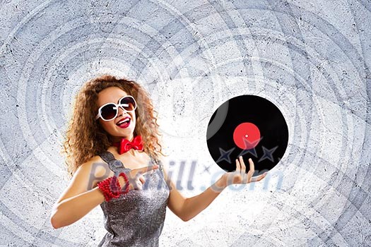 Young pretty girl dj at disco party holding vinyl Young pretty girl dj at disco party holding vinyl