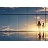 Silhouettes of businesspeople standing against panoramic office window