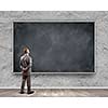 Rear view of businessman looking at chalkboard