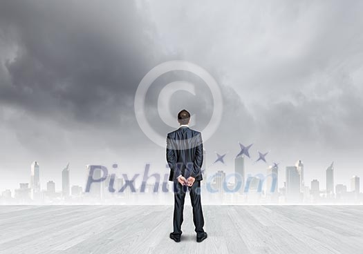 Back view of confident businessman looking at city Back view of confident businessman looking at city