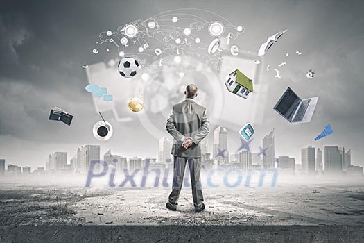 Back view of confident businessman looking at city with items flying in air Back view of confident businessman looking at city with items flying in air