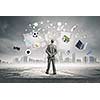 Back view of confident businessman looking at city with items flying in air