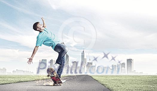 Skater in jeans riding on road against city background Skater in jeans riding on road against city background