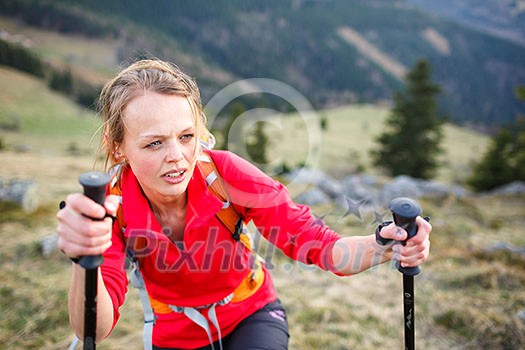 Pretty, young female hiker having a tough walk uphill Pretty, young female hiker having a tough walk uphill