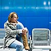 Sad and alone in a big city - Depressed young woman sitting in a metro station, feeling sorrow, regret