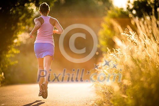 Young woman running outdoors on a lovely sunny summer evening (shallow DOF; color toned image) Young woman running outdoors on a lovely sunny summer evening (shallow DOF; color toned image)