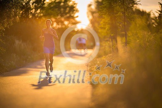 Young woman running outdoors on a lovely sunny summer evening (shallow DOF; color toned image) Young woman running outdoors on a lovely sunny summer evening (shallow DOF; color toned image)