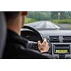 Man driving a car with his hands on the steering wheel