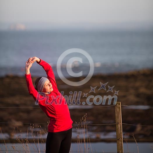 Young woman on her evening jog along the seacoast Young woman on her evening jog along the seacoast