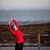 Young woman on her evening jog along the seacoast