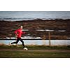 Young woman on her evening jog along the seacoast