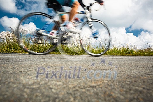 Motion blurred biker on a mountain road