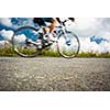 Motion blurred biker on a mountain road