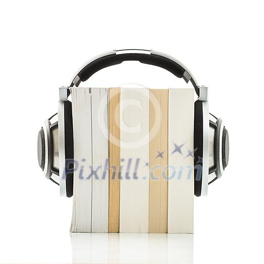 Audiobook concept - listen to your books in HD quality; hi-end hifi headphones over multiple books on white Audiobook concept - listen to your books in HD quality; hi-end hifi headphones over multiple books on white
