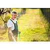 Portrait of a handsome senior man gardening in his garden (color toned image)