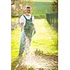 Portrait of a handsome senior man gardening in his garden, on a lovely spring day (color toned image)