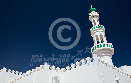 White mosque with minaret against blue sky (Sur, Oman) White mosque with minaret against blue sky (Sur, Oman)