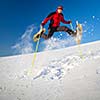 Young man having fun while snowshoeing outdoors on a lovely snowy winter day