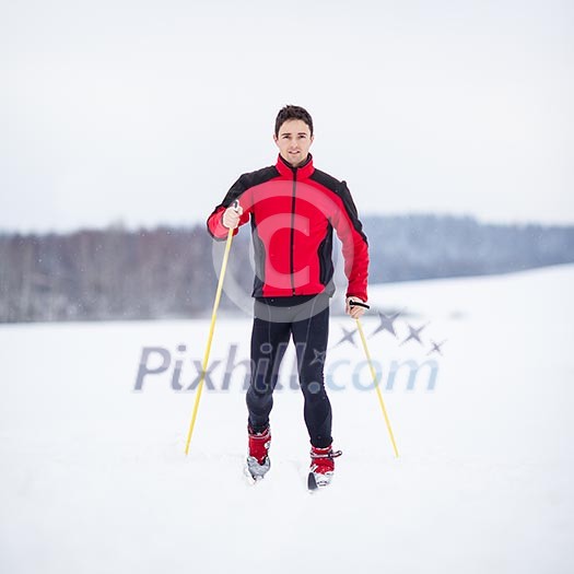 Cross-country skiing: young man cross-country skiing on a lovely snowy winter day Cross-country skiing: young man cross-country skiing on a lovely snowy winter day
