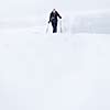 Cross-country skiing: young woman cross-country skiing on a snowy winter day