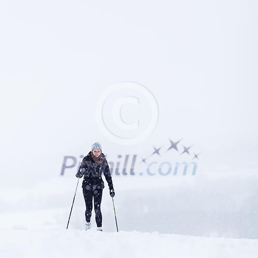 Cross-country skiing: young woman cross-country skiing on a snowy winter day Cross-country skiing: young woman cross-country skiing on a snowy winter day