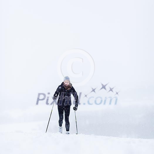 Cross-country skiing: young woman cross-country skiing on a snowy winter day Cross-country skiing: young woman cross-country skiing on a snowy winter day