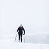 Cross-country skiing: young woman cross-country skiing on a snowy winter day