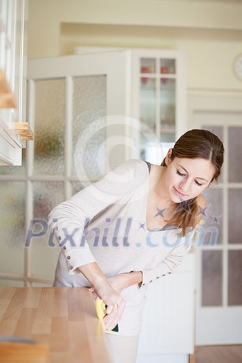 Young woman doing housework, cleaning the kitchen Young woman doing housework, cleaning the kitchen