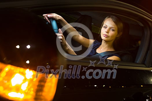 Driving a car at night - pretty, young woman driving her modern car at night, in a city (shallow DOF; color toned image) Driving a car at night - pretty, young woman driving her modern car at night, in a city (shallow DOF; color toned image)