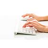 Hands of a person working an a keyboard over white background (color toned image; shallow DOF)