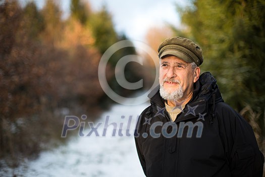 Portrait of a senior man, outdoor on a snowy forest path. Enjoying the crisp fresh air, watching the Sun go down. Portrait of a senior man, outdoor on a snowy forest path. Enjoying the crisp fresh air, watching the Sun go down.