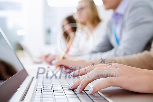 Close up image of young people using laptop at classroom Close up image of young people using laptop at classroom