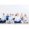 group of young people meditating on table in classroom