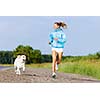 Young healthy girl running outdoor with her dog