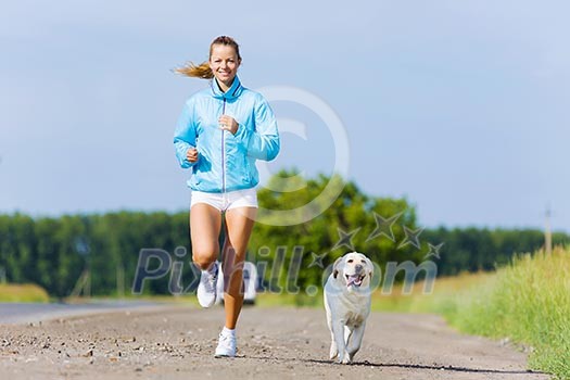 Young healthy girl running outdoor with her dog Young healthy girl running outdoor with her dog