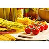 Cherry tomatoes and vegetables on kitchen table