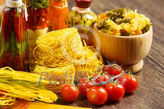 Cherry tomatoes and vegetables on kitchen table Cherry tomatoes and vegetables on kitchen table