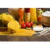Cherry tomatoes and vegetables on kitchen table