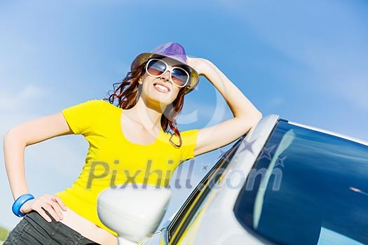Young pretty woman leaning out of car window Young pretty woman leaning out of car window