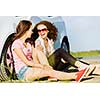 Young pretty women sitting near white car at side of road