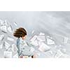 Young tired businesswoman with waving hair among flying documents