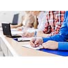 Close up image of young people using laptop at classroom