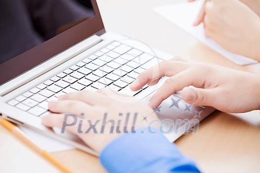 Close up image of young people using laptop at classroom Close up image of young people using laptop at classroom