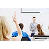 Young teacher in classroom standing in front of class