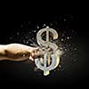 Close up image of human hand breaking dollar stone symbol