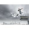 Young businessman jumping over bridge gap. Risking in business