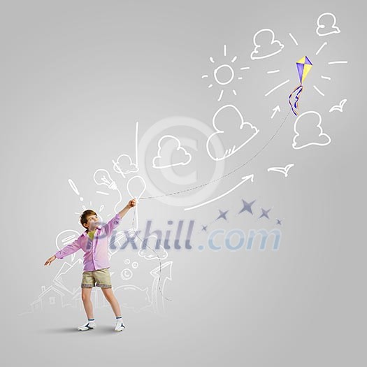 Little boy playing with kite against gray background. Childhood concept Little boy playing with kite against gray background. Childhood concept
